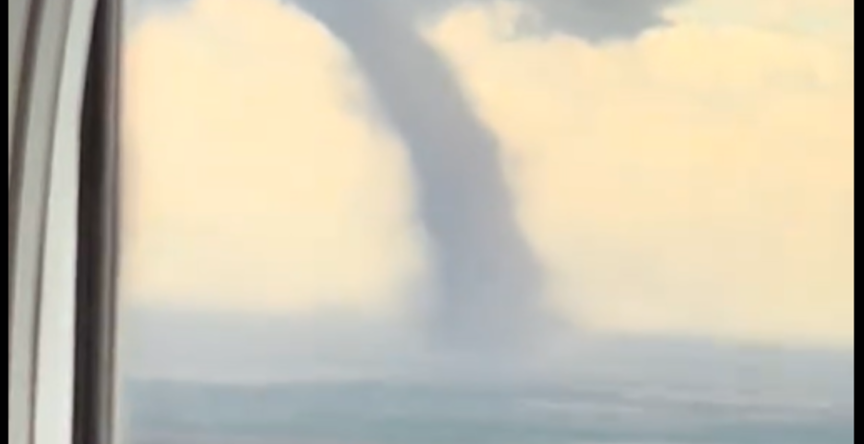 Passenger Looks Out The Window On Plane, Spots Tornado Swirling Beside Them